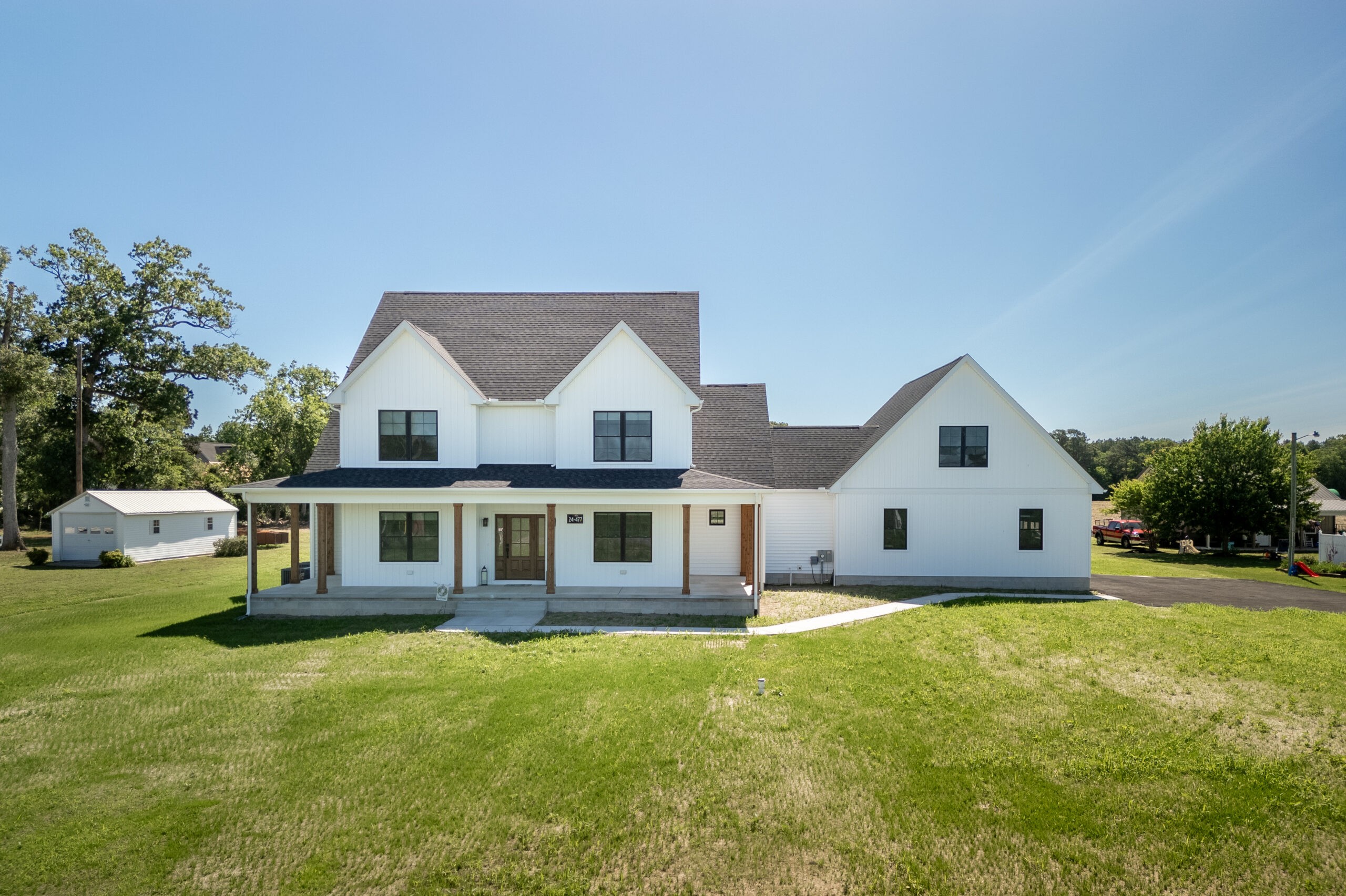 Newly constructed modern house on a green lot showcasing the benefits of a land home package.
